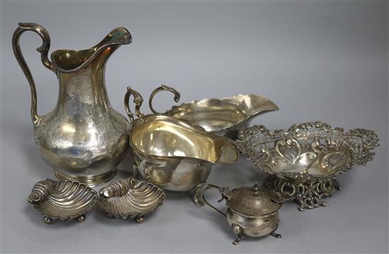 A Victorian engraved silver cream jug, two silver sauceboats, a pierced silver bonbon dish, two silver salts and a silver mustard.